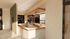 Elegant kitchen bar area with modern lighting and stylish wine rack, perfect for entertaining.