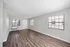 Spacious and bright living area with elegant wooden floors, large windows, and modern finishes.
