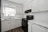 Bright and inviting kitchen with modern appliances, elegant white cabinetry, and a sleek countertop, perfect for culinary creativity.