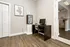 Elegant and cozy office nook with a minimalist desk, chic computer setup, and modern art, perfect for a productive work environment.