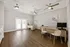 Bright and modern office space featuring sleek desks, comfortable seating, and elegant ceiling fans, perfect for productivity.
