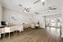 Bright and welcoming office space with modern desks, elegant flooring, and stylish ceiling fans, perfect for productive workdays.