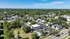 Charming suburban apartment complex surrounded by lush greenery, offering modern living with a pool and ample parking.