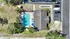 Inviting aerial view of a luxurious apartment complex with a sparkling outdoor pool, surrounded by lush greenery and convenient parking.