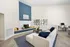 Elegant living room with a cozy fireplace, modern decor, and ample natural light, perfect for relaxation and work-from-home setup.