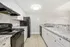 Modern kitchen with elegant white cabinetry, sleek countertops, and energy-efficient appliances.