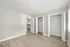 Bright, spacious bedroom with sleek hardwood flooring, ample closet space, and natural light filtering through large windows.
