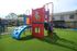 Vibrant playground with colorful slides and climbing structures, surrounded by lush greenery and secure fencing in a family-friendly community.