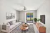 Bright and airy living room featuring a cozy beige sofa, stylish striped rug, and modern entertainment center, with large sliding glass doors leading to a peaceful outdoor view.