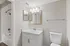 Bright and modern bathroom featuring elegant vanity lighting, sleek white countertop, and stylish bathtub for a sophisticated living experience.