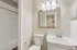 Bright and modern bathroom featuring a sleek white vanity, stylish mirror, and inviting bathtub, offering a refreshing oasis for relaxation.