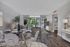 Elegant open-plan living area featuring stylish dining setup, cozy seating, and floor-to-ceiling windows leading to a serene balcony view.