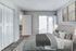 Bright and airy bedroom with plush gray bedding, elegant decor, and access to a private balcony for serene outdoor views.