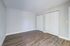 Spacious bedroom featuring elegant wood flooring and dual closets for ample storage.