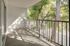 Inviting balcony with elegant railing and lush tree views, perfect for relaxing outdoor moments in a serene setting.
