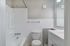 Modern bathroom design featuring a pristine white bathtub, sleek vanity, and elegant tile accents.