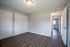 Spacious bedroom with elegant wood flooring, ample closet space, and soft natural lighting.