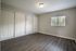 Bright, spacious bedroom with sleek hardwood flooring and ample closet space, perfect for stylish living.
