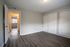 Bright, spacious bedroom with sleek wood flooring and ample closet space, offering a versatile canvas for personalized decor.