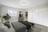 Bright and modern bedroom with stylish decor, spacious closet, and a large window providing natural light.