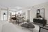 Modern open-concept living and dining area with sleek kitchen, stylish decor, and abundant natural light.
