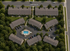 Aerial view of upscale apartment complex featuring charming residential buildings, lush green surroundings, and a central communal pool.