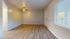 Spacious and bright living area with modern hardwood flooring and ample natural light from large window.