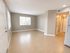 Bright and spacious living area with large windows, elegant tile flooring, and modern recessed lighting, ideal for cozy living.