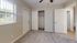 Inviting bedroom with plush carpet, a spacious closet, and large window offering natural light and tranquil views.