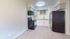 Modern kitchen with sleek black appliances, granite countertops, and ample cabinet space, perfect for culinary enthusiasts.