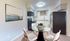 Chic apartment kitchen with modern appliances, cozy dining area, and elegant wall art.
