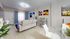 Bright and modern living room with elegant white sofas, stylish decor, and vibrant artwork, perfect for relaxation and entertaining.