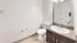 Modern bathroom with elegant granite countertop and sleek white fixtures, perfect for a contemporary apartment.