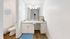 Bright and modern bathroom featuring a sleek vanity with granite countertop, stylish lighting, and elegant wood flooring.