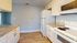 Modern kitchen with sleek granite countertops, white cabinetry, and contemporary appliances in a bright, inviting space.