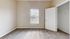 Sunlit bedroom with plush carpeting, neutral walls, and a spacious closet, perfect for creating a cozy retreat.