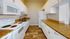 Modern kitchen with sleek granite countertops, elegant white cabinetry, and energy-efficient appliances.