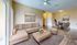 Inviting living and dining space with modern decor, featuring a plush sectional sofa, round dining table with elegant chairs, and tasteful artwork.