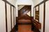 Historic lobby at Old Heidelberg Apartments featuring terracotta tile flooring, wood trim, built-in seating, and a decorative staircase.