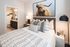 Studio Apartments in Gainesville, GA - The Mill at New Holland - Bedroom with En-Suite Bathroom, Stylish Decor, and Beige Walls