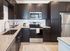 Apartments in Gainsville, GA for Rent - The Mill at New Holland - Kitchen with Dark Wood-Style Cabinets, Stainless Steel Appliances, and Kitchen Island