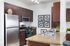 Kitchen with stainless steel appliances and brown wooden cabinets