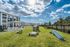 Bright and inviting community playground with a sunlit sky, featuring playful equipment amidst lush greenery, ideal for family fun.