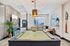 Chic entertainment lounge featuring a modern pool table, cozy seating area, and stylish brick accent wall.