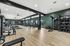 Expansive fitness center with state-of-the-art equipment, sleek wooden flooring, and a modern design.