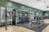 Modern fitness center with state-of-the-art gym equipment, weight racks, and a stylish interior design.