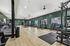 Modern fitness center with state-of-the-art gym equipment, sleek wooden floors, and ample natural light.