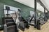 Modern fitness center featuring state-of-the-art treadmills and a stair climber against an inviting green wall.
