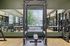 Modern gym interior featuring state-of-the-art fitness equipment with mirrored walls and stylish wood flooring.