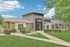 Inviting exterior of The Foundry with modern architecture, lush green landscaping, and clear blue sky.